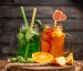 top-view-fresh-delicious-fruit-juices-served-with-apple-feijoas-oranges-wooden-cutting-board